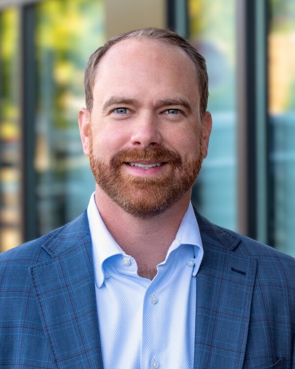Joey Morganthall, man smiling outside in a blue blazer