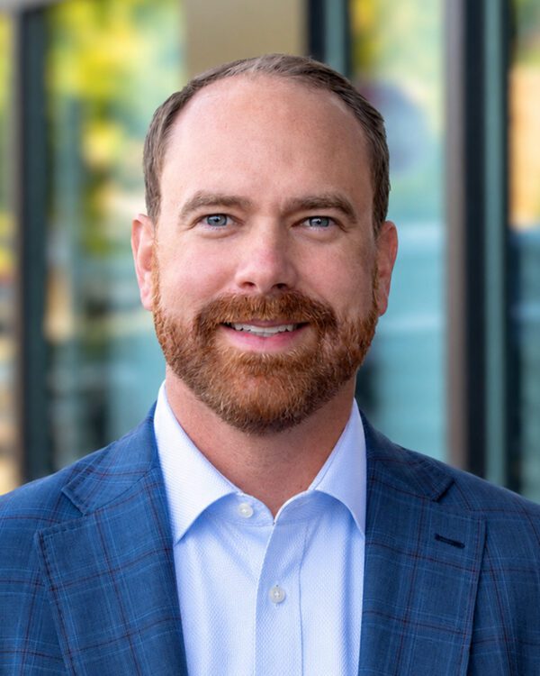 Joey Morganthall retail broker man with red beard smiling outside