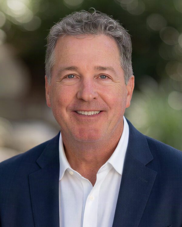 Mike Chatham broker male with gray hair in business attire smiling outside
