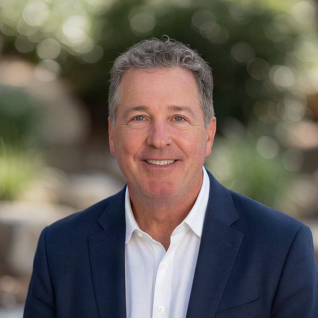 Mike Chatham broker male with gray hair in business attire smiling outside