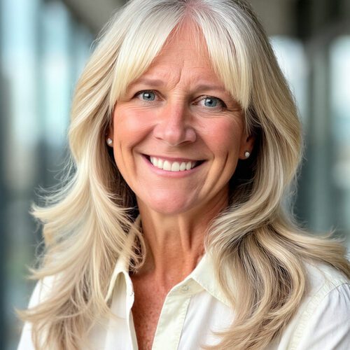 Shannon Stanley property operations middle-aged woman with flowing blonde hair in a cream blouse in an office building setting