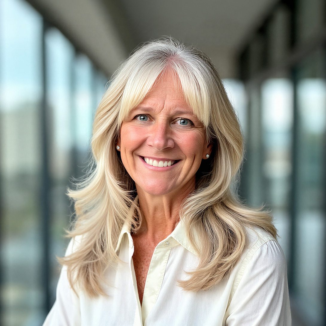 Shannon Stanley property operations middle-aged woman with flowing blonde hair in a cream blouse in an office building setting
