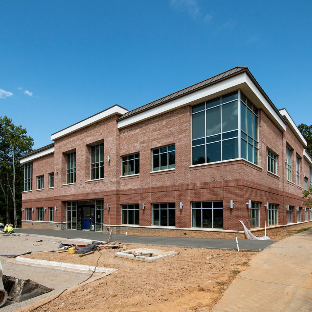 medical office building under development 2-story redish brick with new concrete poured for sidewalk