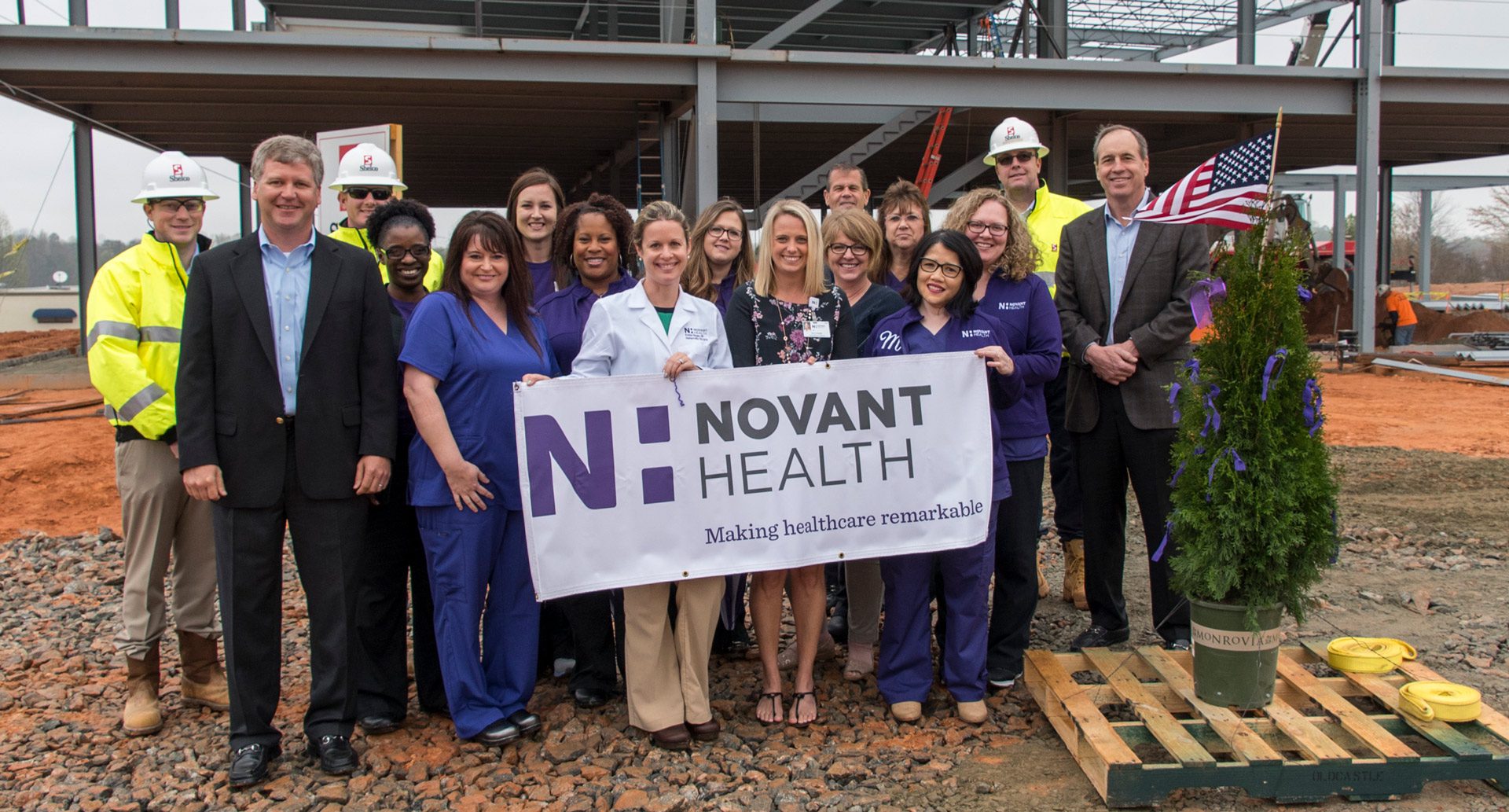 Denver-Medical-Novant-Topping-Out Shelco group outside physicians and developers smiling near steel frame