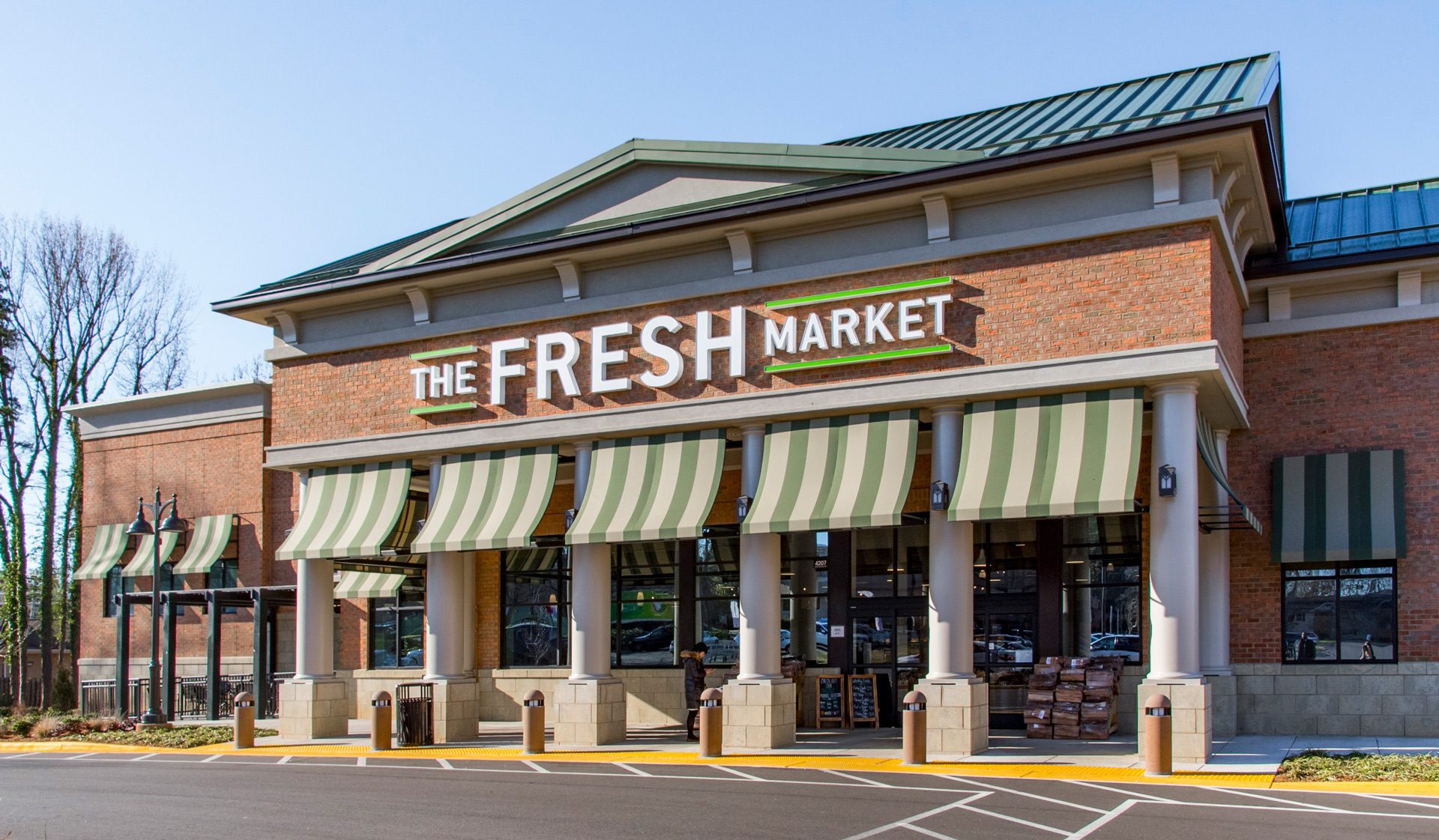 Strawberry Hill The Fresh Market exterior main entrance brick and striped green awnings