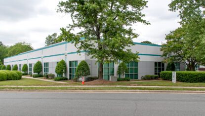 5001 Airport Center industrial flex building exterior white with teal trim