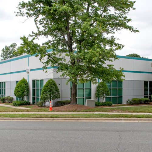 5001 Airport Center industrial flex building exterior white with teal trim
