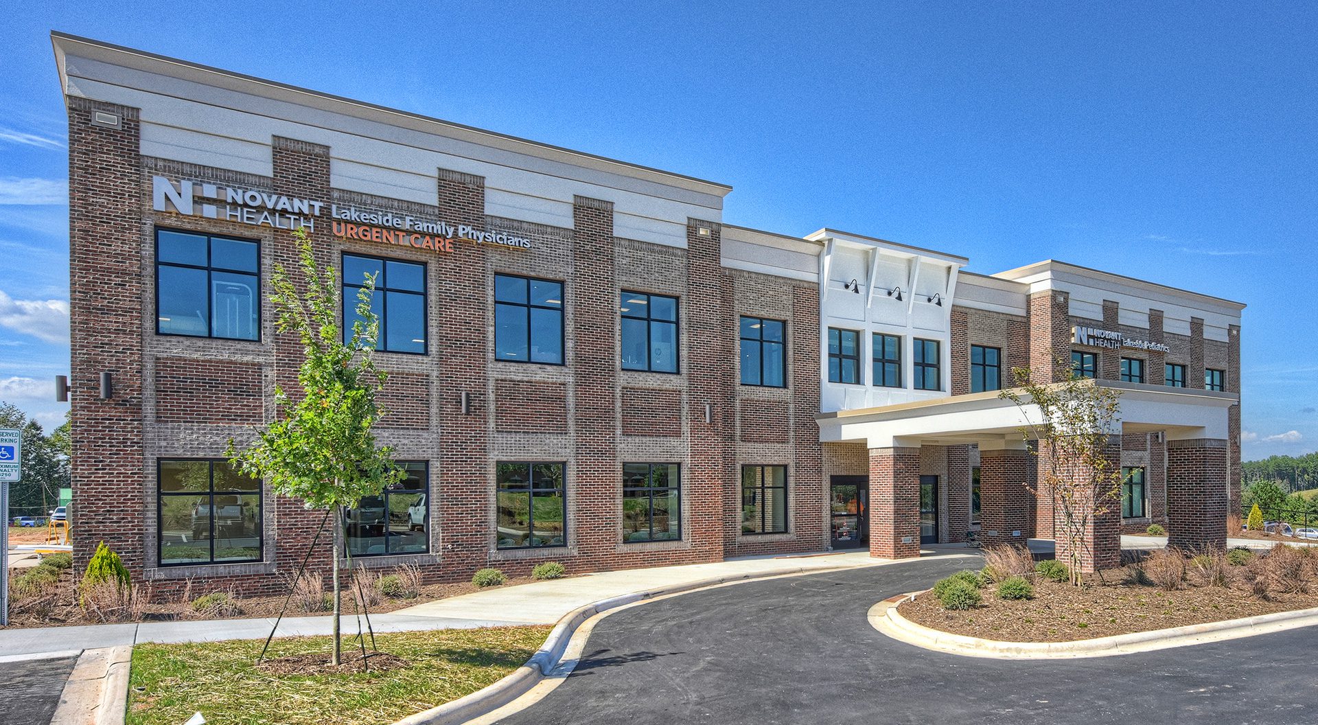 Novant Health 2-story brick MOB medical office building on a sunny day with a covered drive thru awning entrance