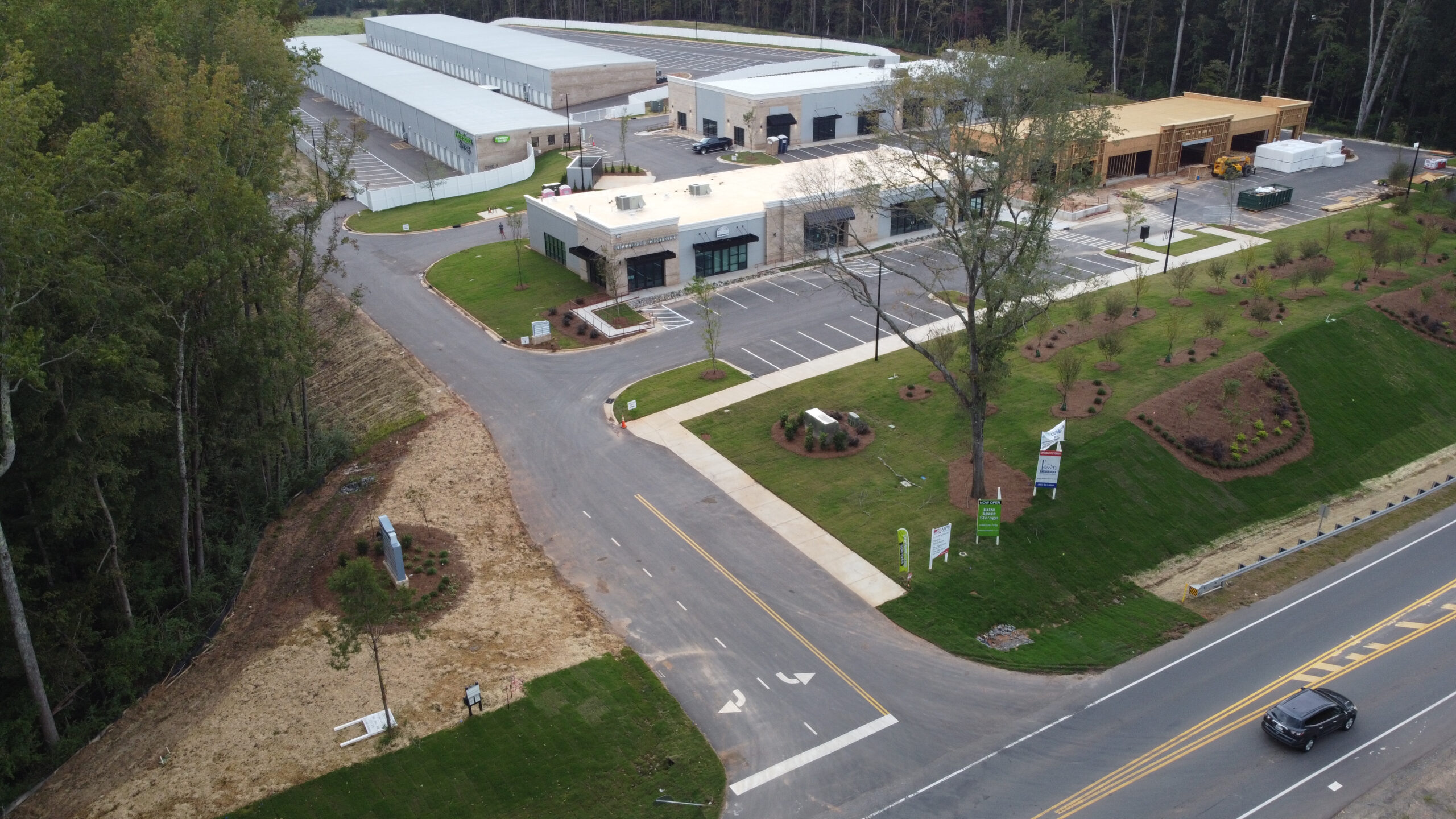 Aerial view of white buildings with parking lot