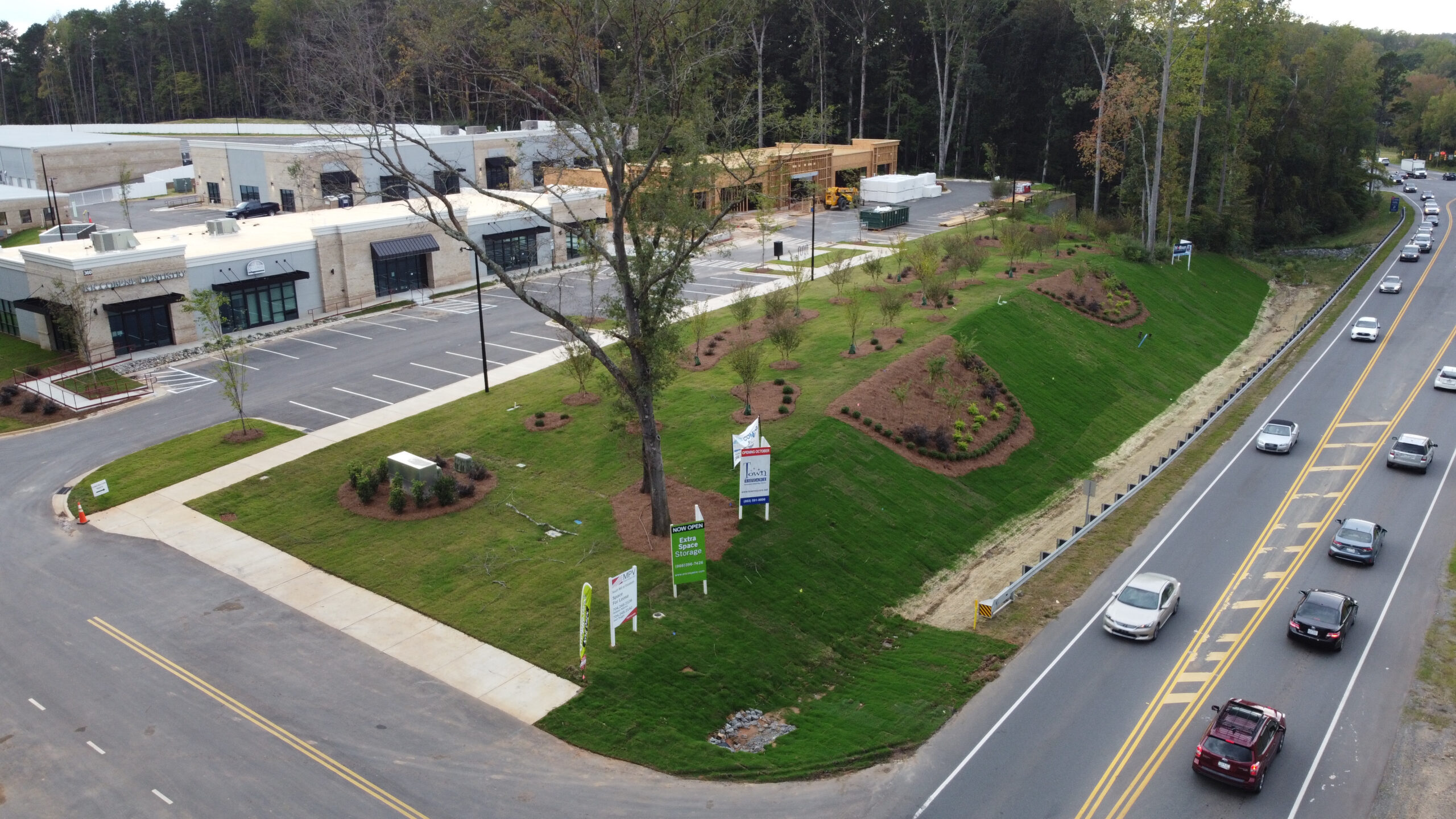 Aerial view of white buildings with parking lot