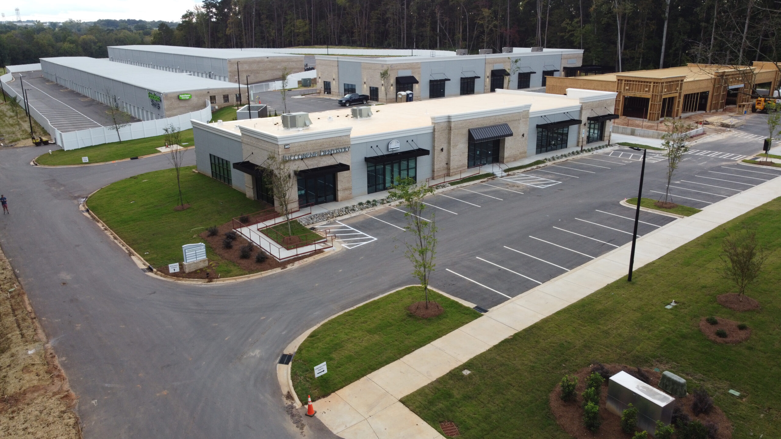 Aerial view of white buildings with parking lot