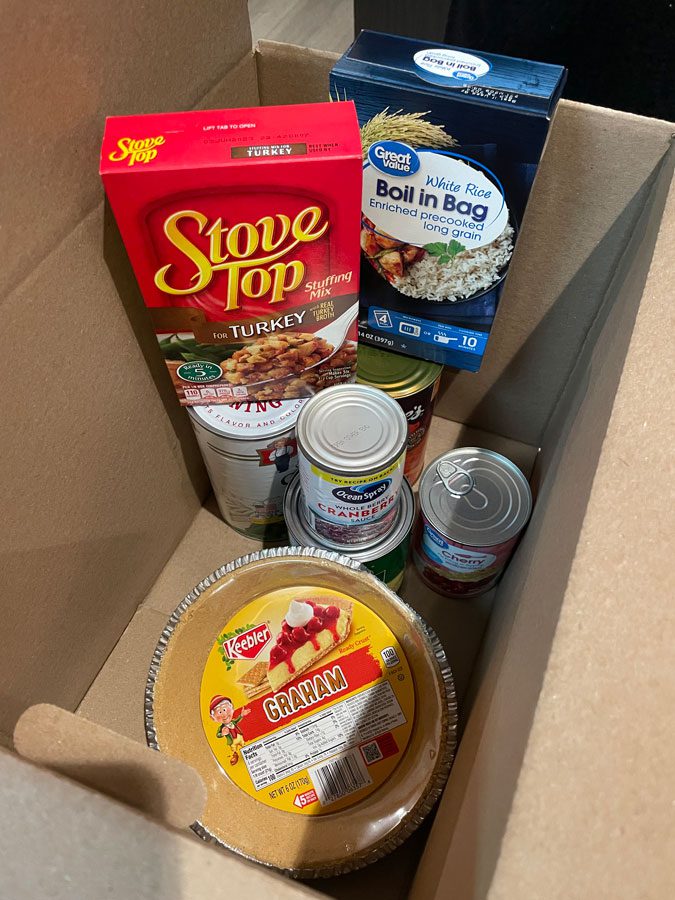 Salvation Army Thanksgiving food box with stuffing, pie crust, cranberry sauce and rice inside
