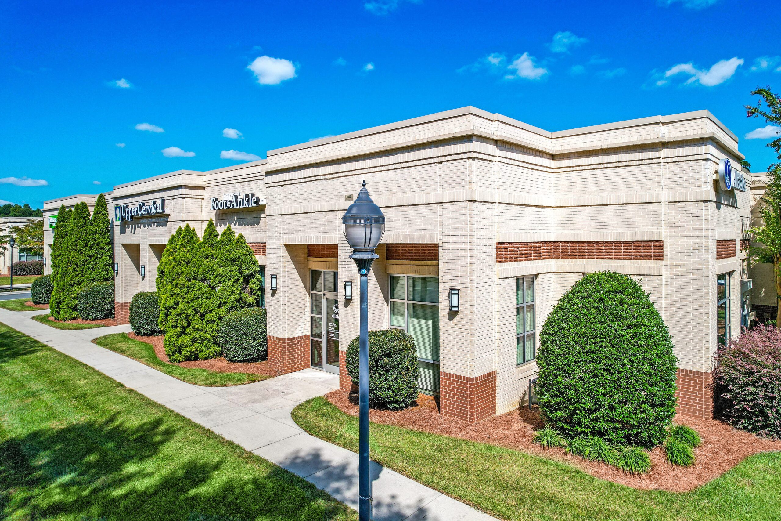 2550 W Arrowood Road Exterior Photo-White Building with Lamp post