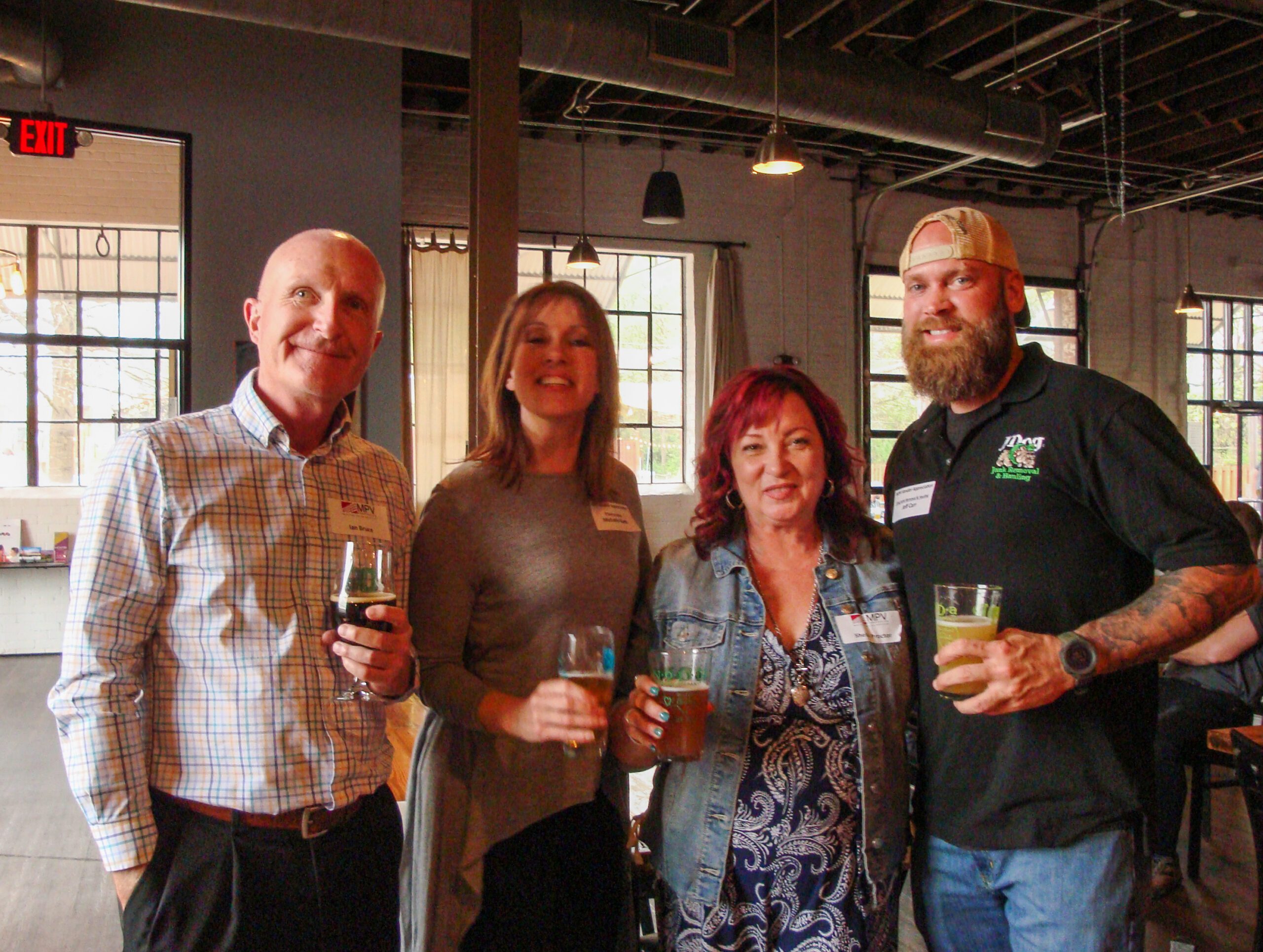 MPV Association Management team and vendors at NoDa Brewery four adults smiling