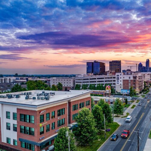 MPV Properties building at sunrise with uptown Charlotte in the background and a brilliant colorful sky