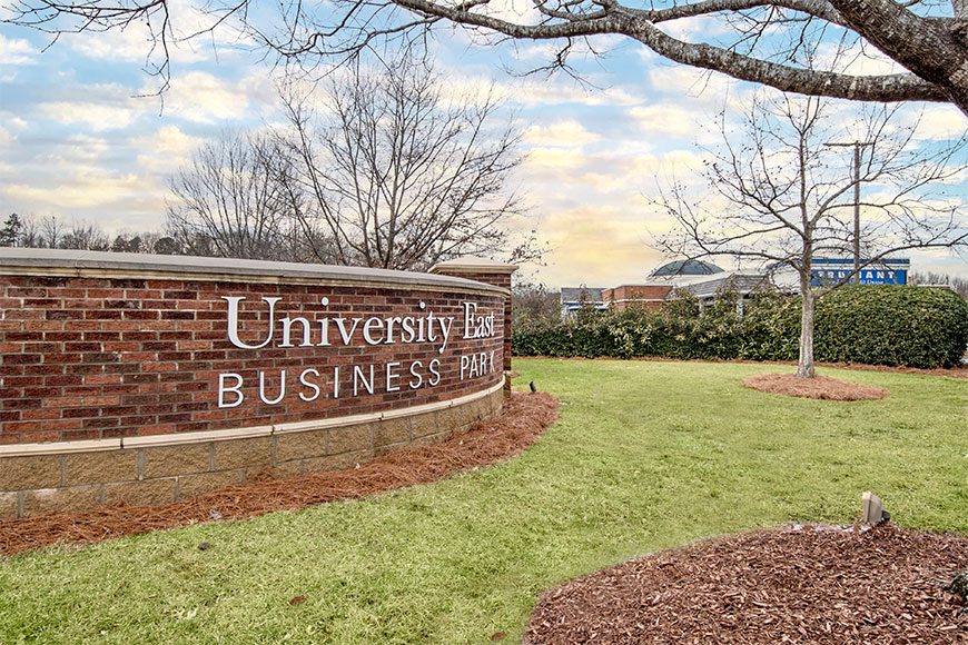 Monument sign that says "University East Business Park"