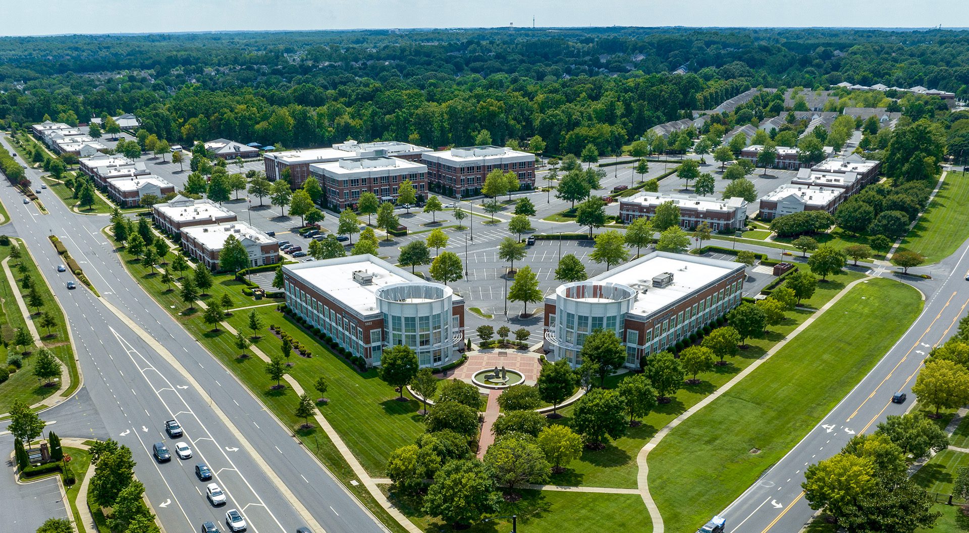 Aerial of Blakeney Professional Center in Charlotte, NC. A dozen or so brick medical office buildings with lots of trees and grass surrounding class A office