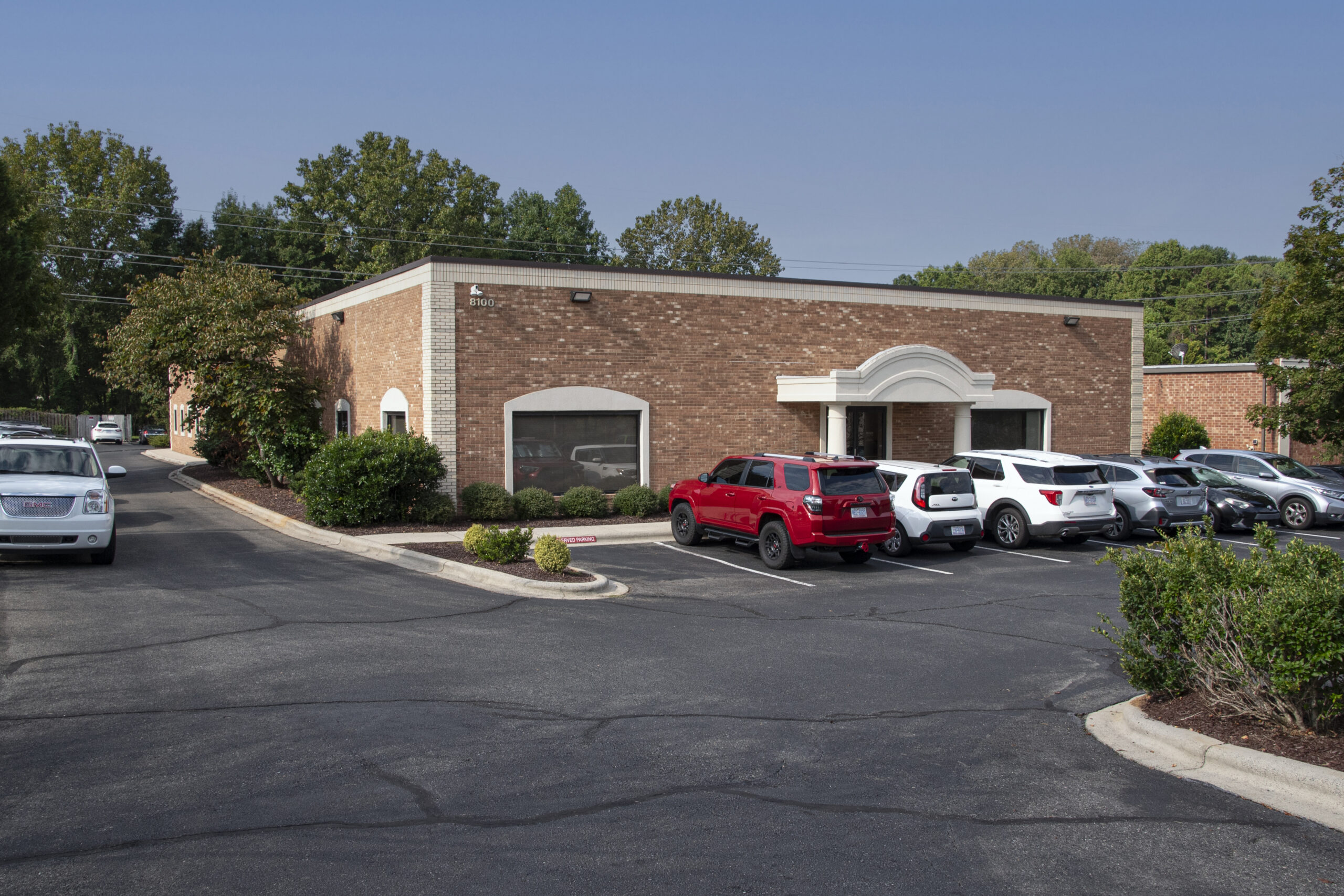 Exterior of Brick Office Building with cars in front