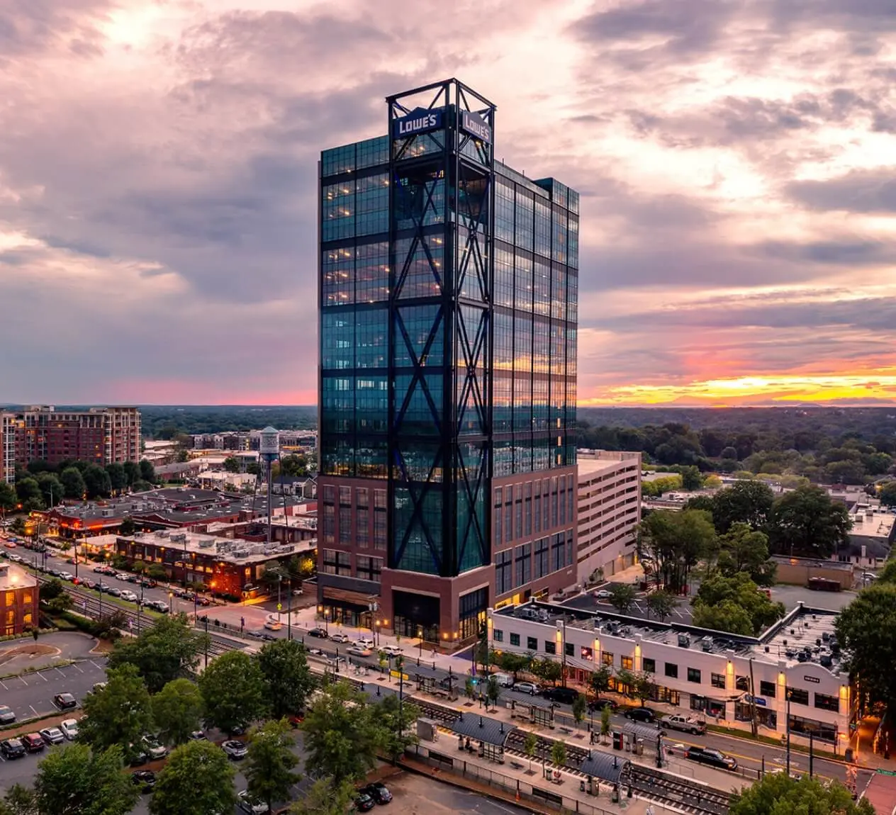 Lowe's Tech Hub high-rise office building in South End, Charlotte, NC mostly glass and black steel exterior at sunset