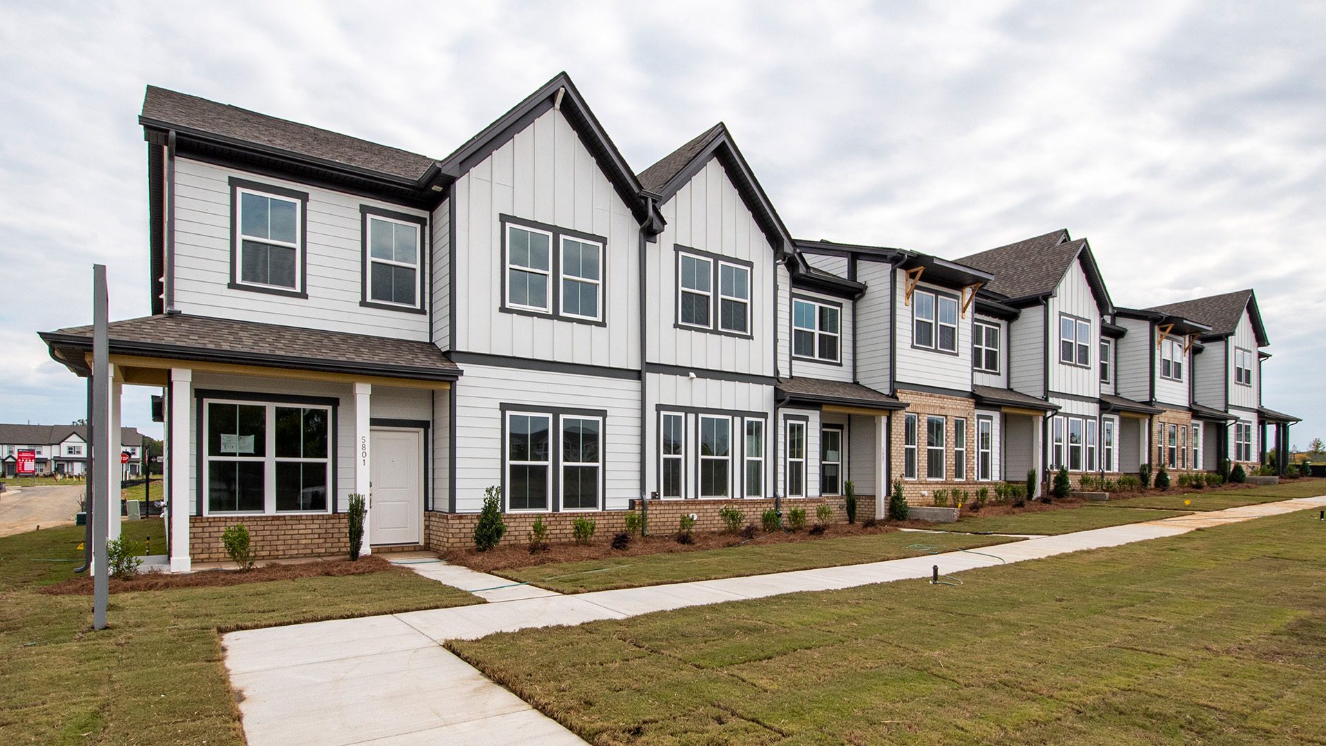 newly finished 2-story townhomes at Farmington with white siding and gray roofs