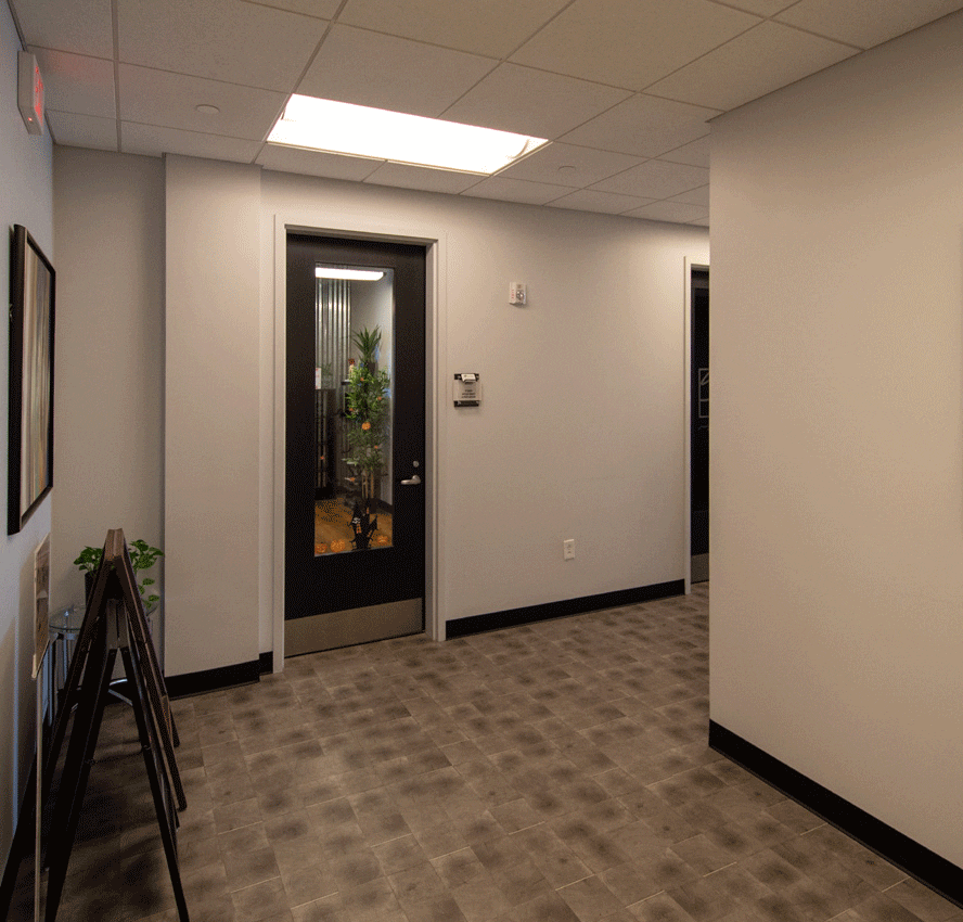 Phyiscal Therapy Hallway with Door and grey carpet