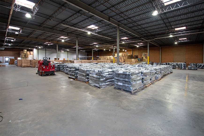 Interior of large industrial warehouse building with concrete floors