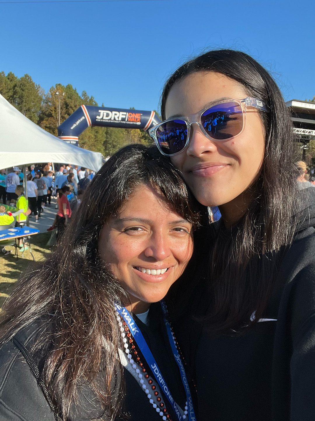 MPV team mother and daughter at JDRF One Walk smiling on sunny morning