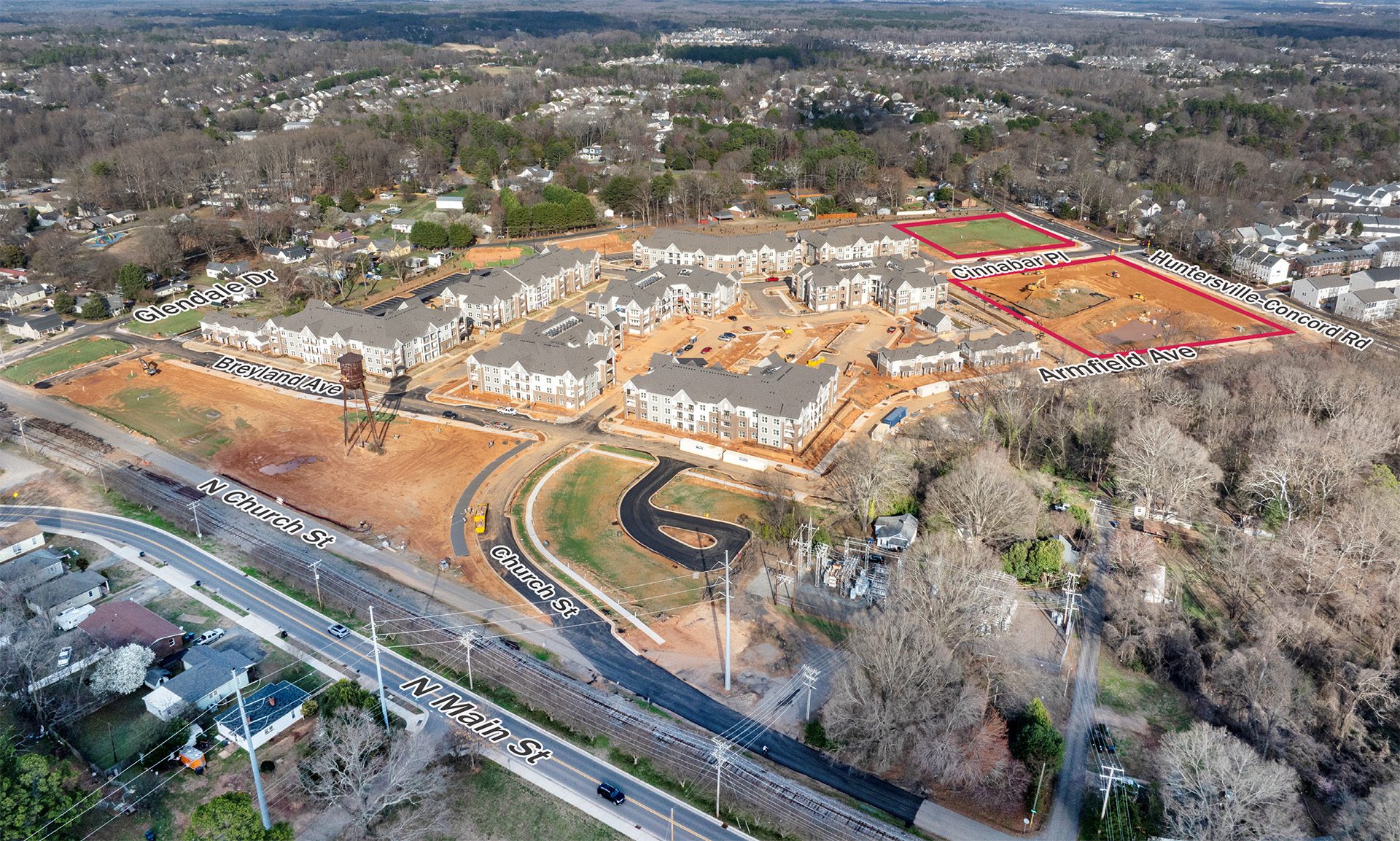 Vermillion Village aerial as of March 2026 showing construction progress and residential buildings from Main St.