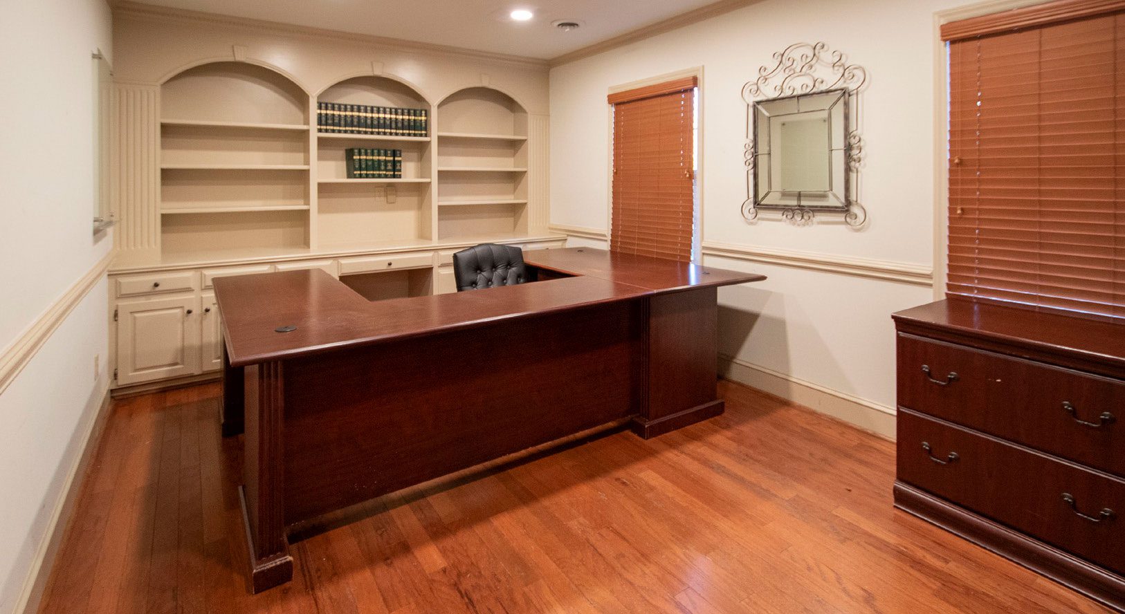 Office with large wooden desk and cut outs in the wall