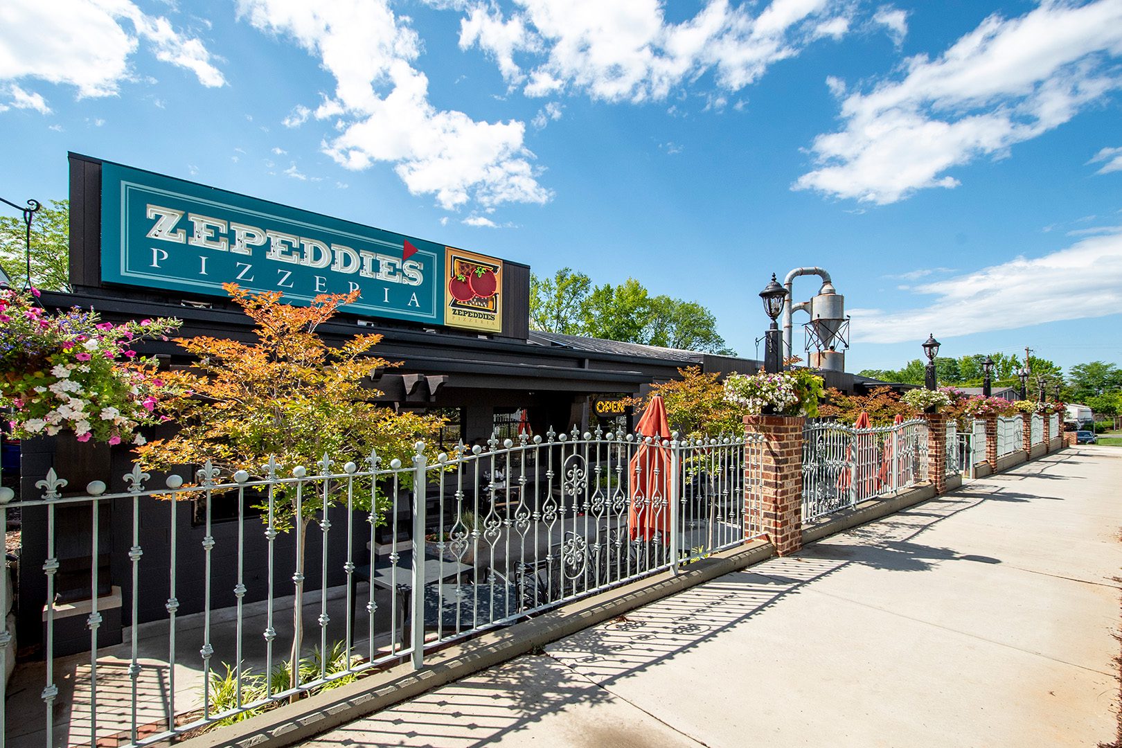 4516 Nations Crossing exterior building front with Zepeddie's Pizza and fence