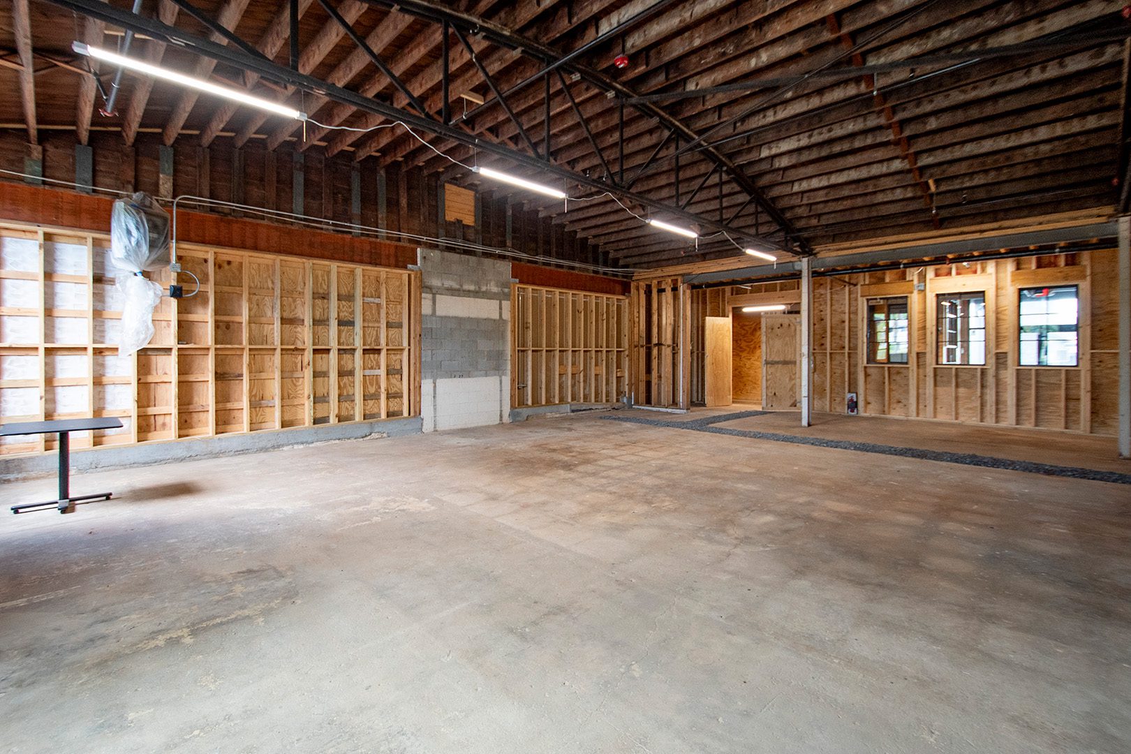 interior retail shell space with exposed framing and barrel roof