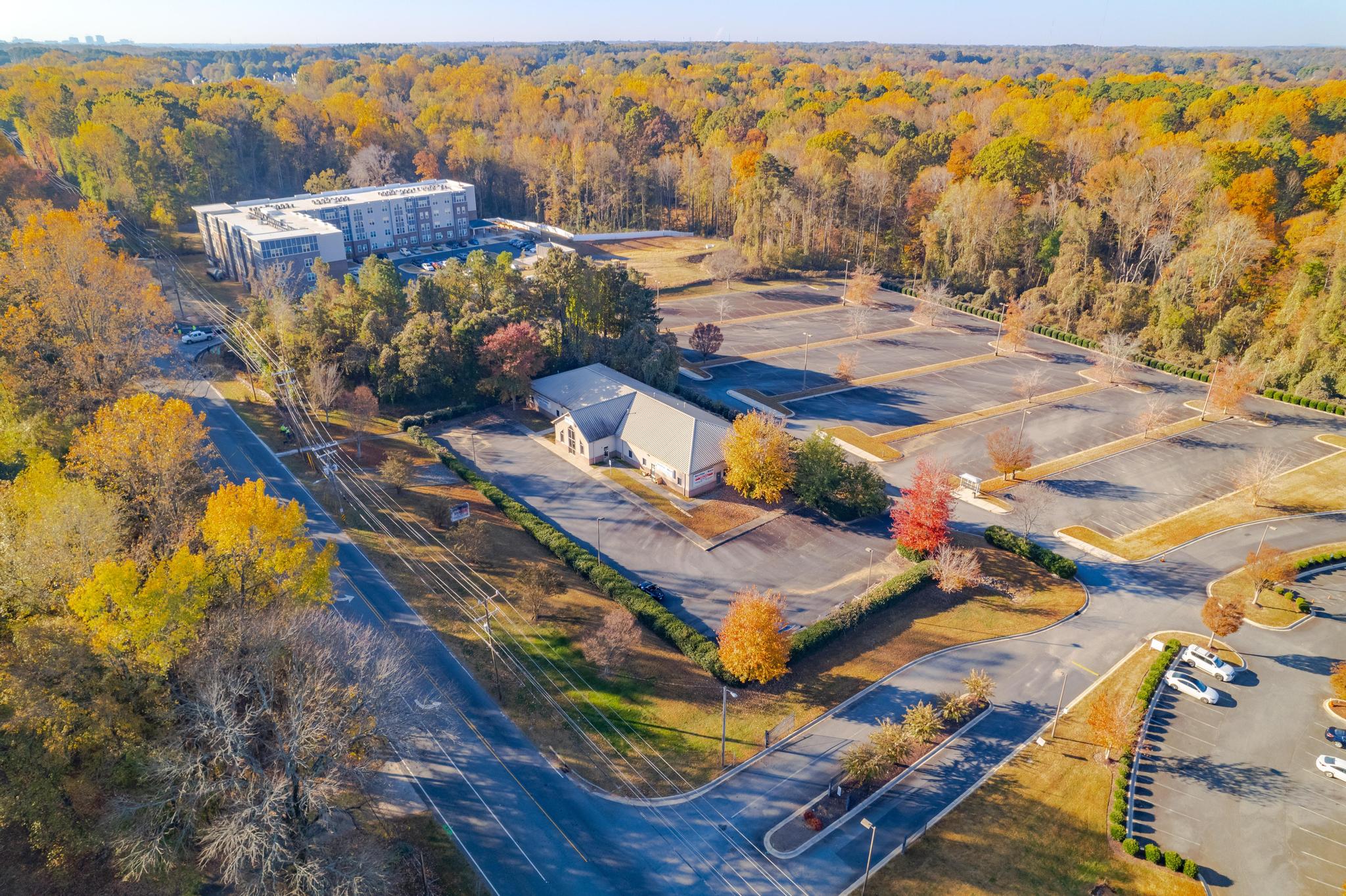 Front Drone View of one story Medical Office building with parking lot