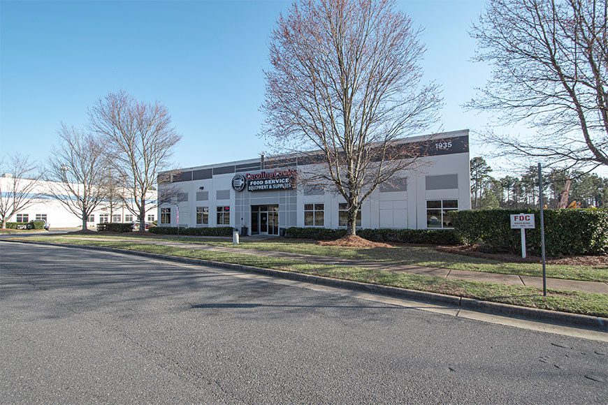 White Building with tree in front