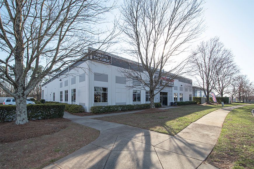 White Building with tree in front