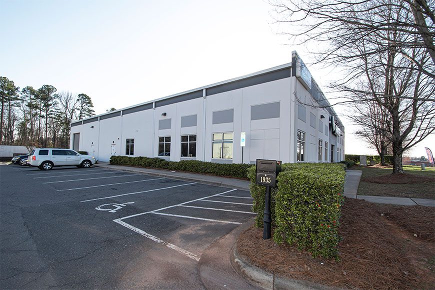 White Building with tree in front