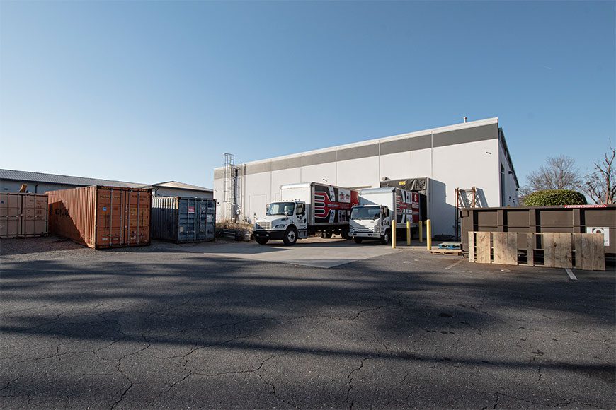 Back of White Building with trucks