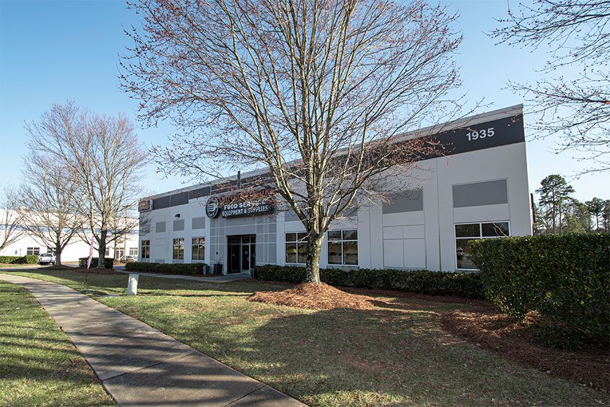 White Building with tree in front