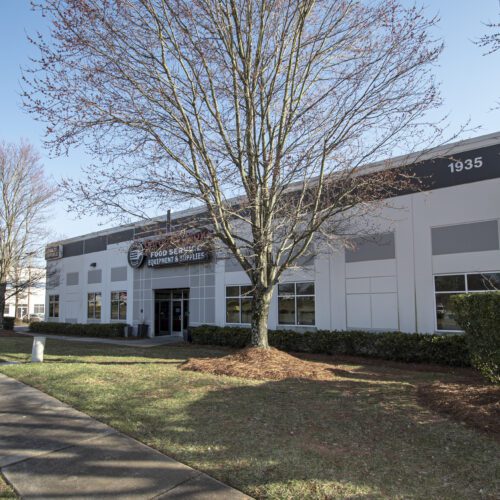 White Building with tree in front