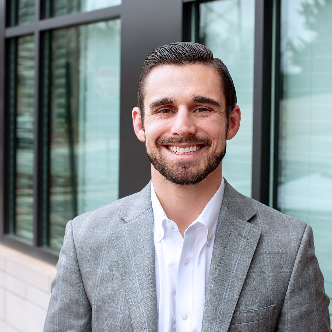 Chad Pyke white male with dark hair smiling outside an office building