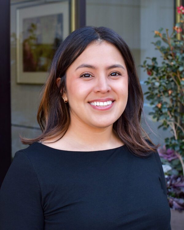 Anissa Aguero smiling young woman in a black shirt with dark hair