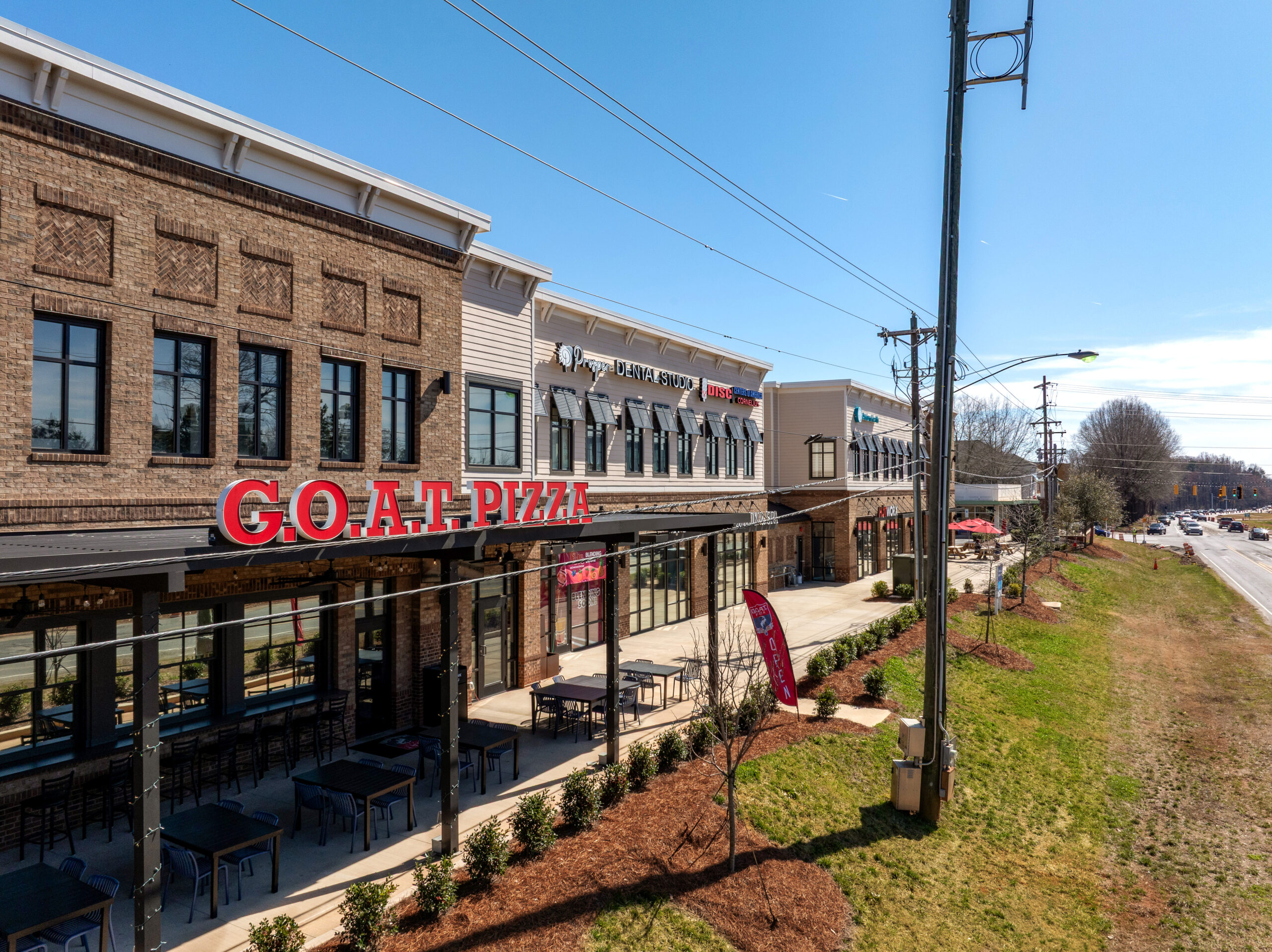 Brick Multi Tenant 2 story building with Goat Pizza Sign