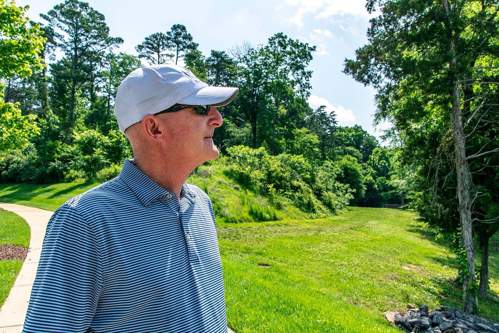 Ian Bruce Director of Association Management white male in a striped blue polo shirt and white baseball cap