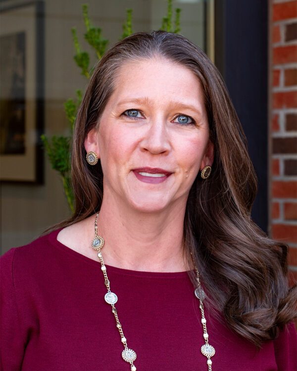 Renee Rice property manager at MPV Properties woman with long brown hair and a burgundy top