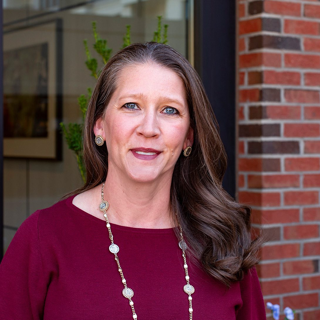 Renee Rice property manager at MPV Properties woman with long brown hair and a burgundy top