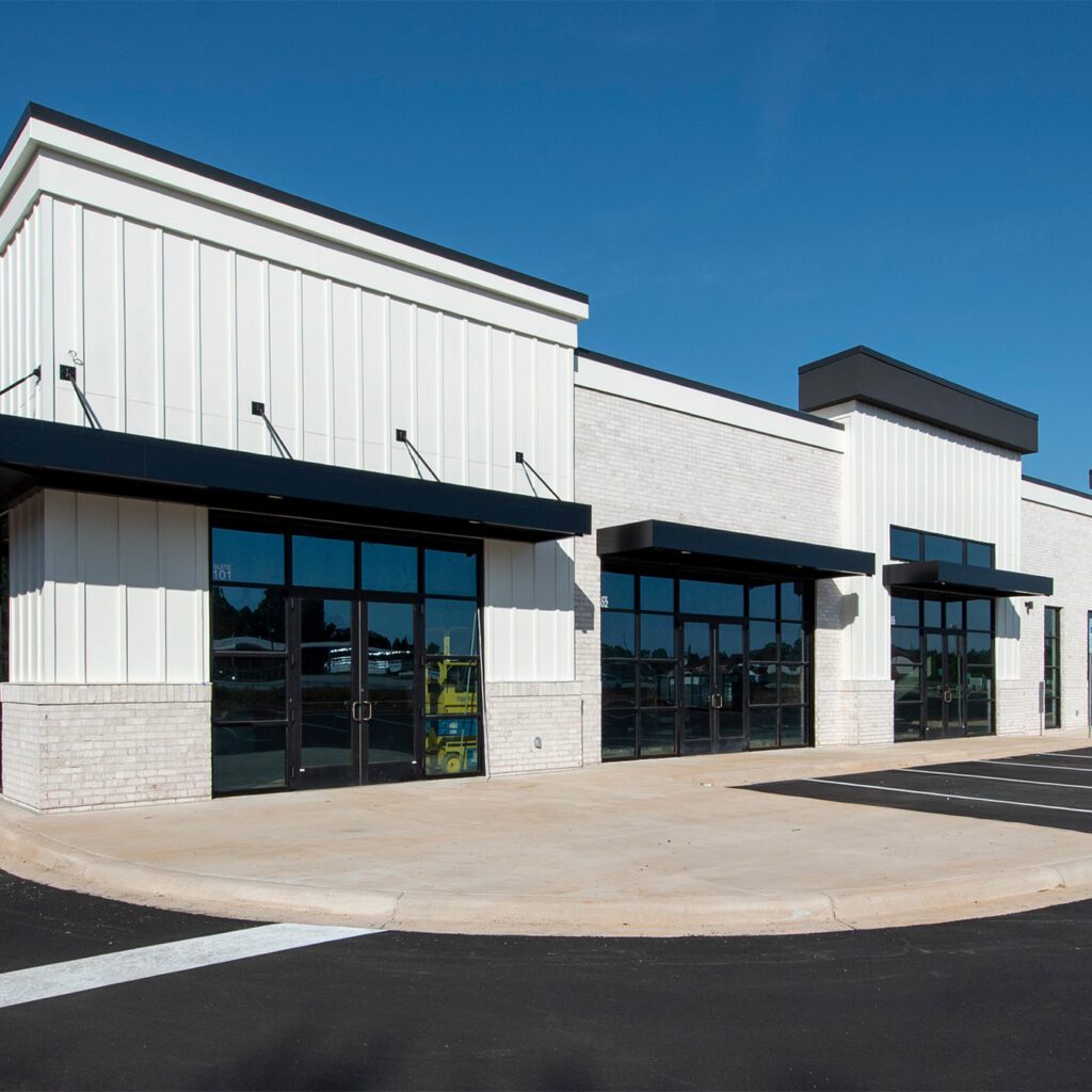new construction multi-tenant retail or medical building with white exterior and black windows