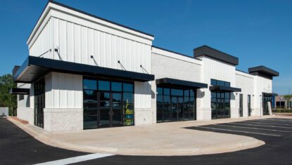 new construction multi-tenant retail or medical building with white exterior and black windows