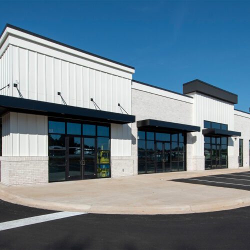 new construction multi-tenant retail or medical building with white exterior and black windows
