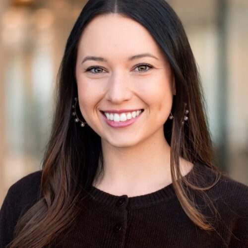 Meredith Choate young woman with brunette hair smiling in an office setting