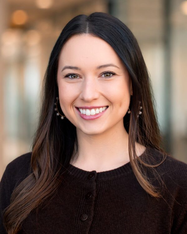 Meredith Choate young woman with brunette hair smiling in an office setting