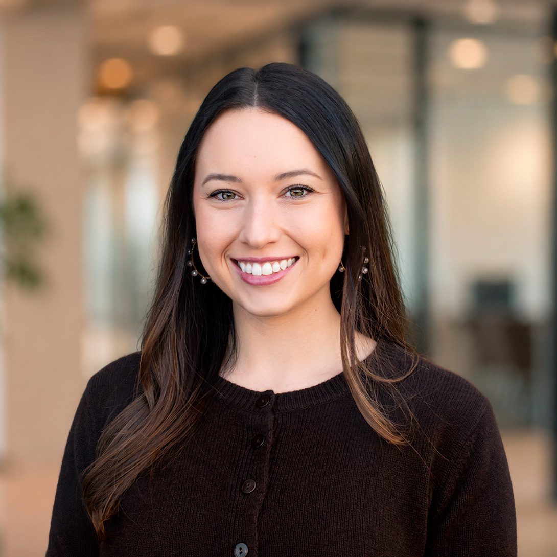 Meredith Choate young woman with brunette hair smiling in an office setting